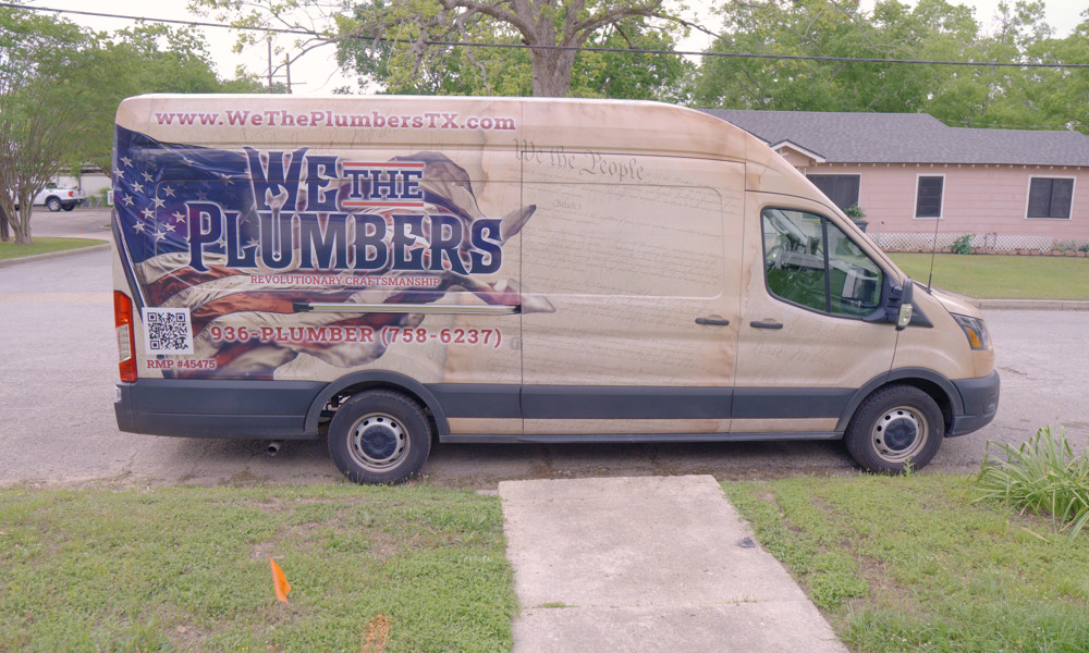 The We The Plumbers van with the company name and master plumber license number