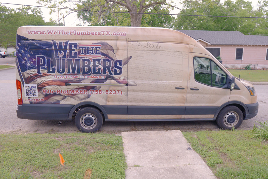 The We The Plumbers van with the company name and license number