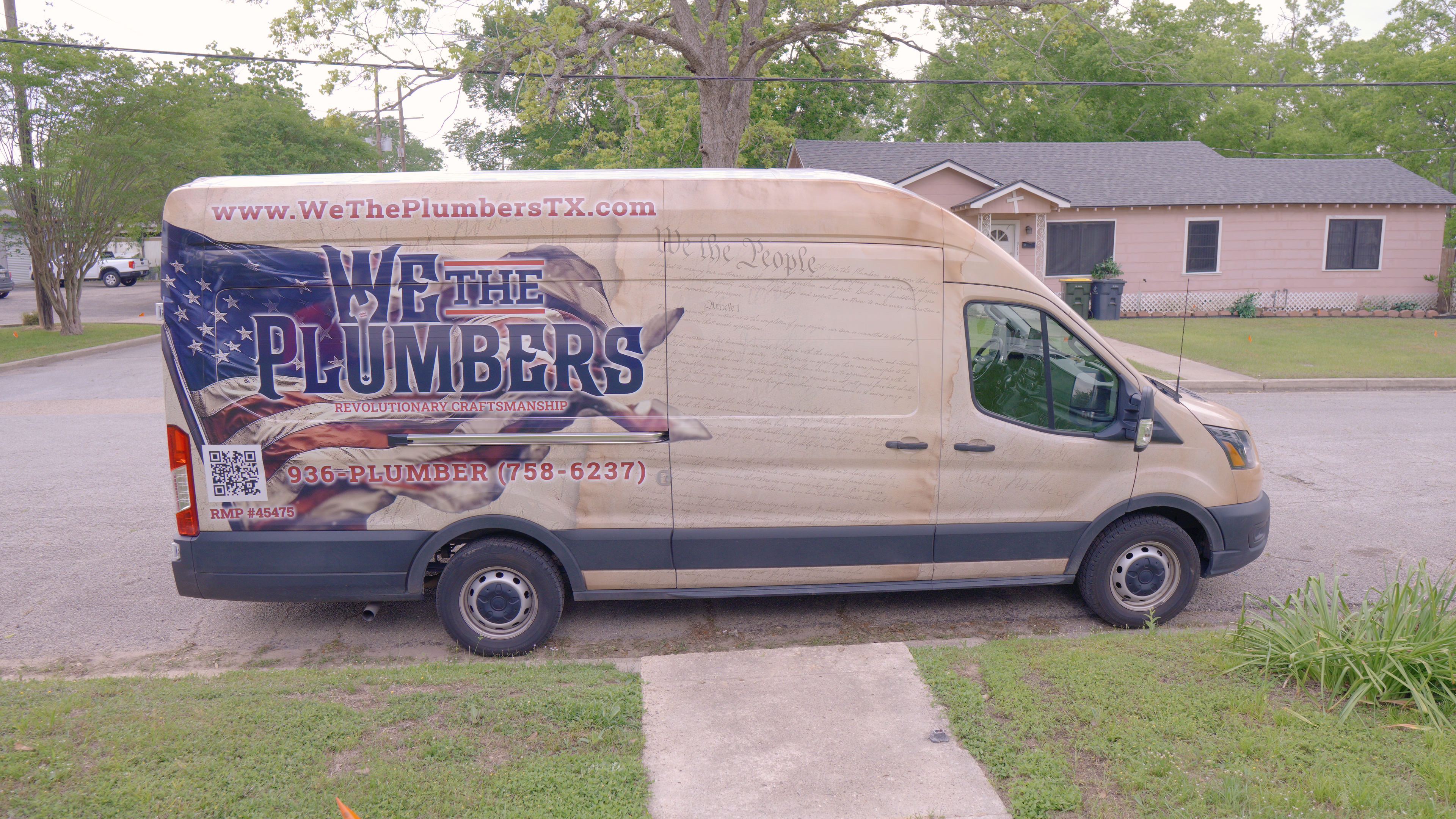 The We The Plumbers van parked on a residential street